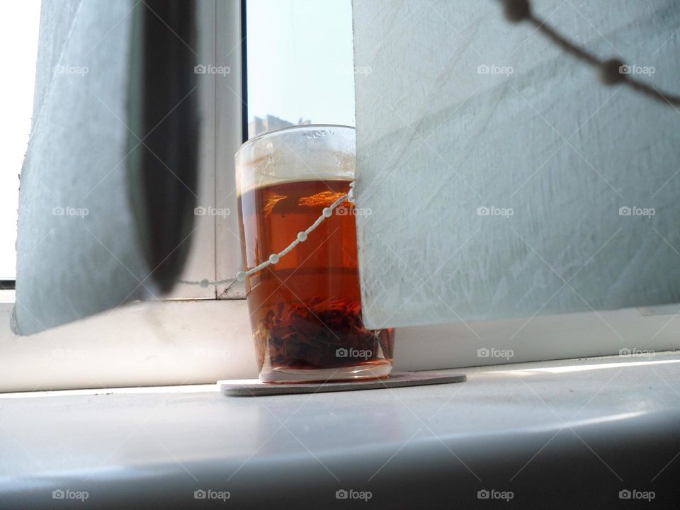 a cup of tea on the windowsill