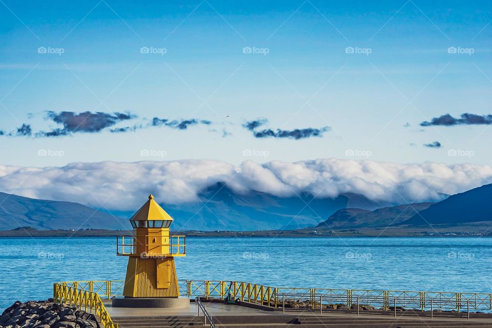 A light house in front of a lake