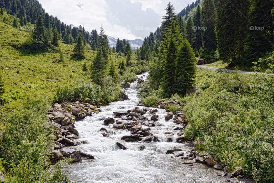 Zillertal alps in austria. High Tauern mountain range. wild stream.