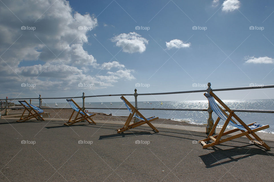 Deckchairs at English seaside. Deckchairs wait for their first customers of the day.