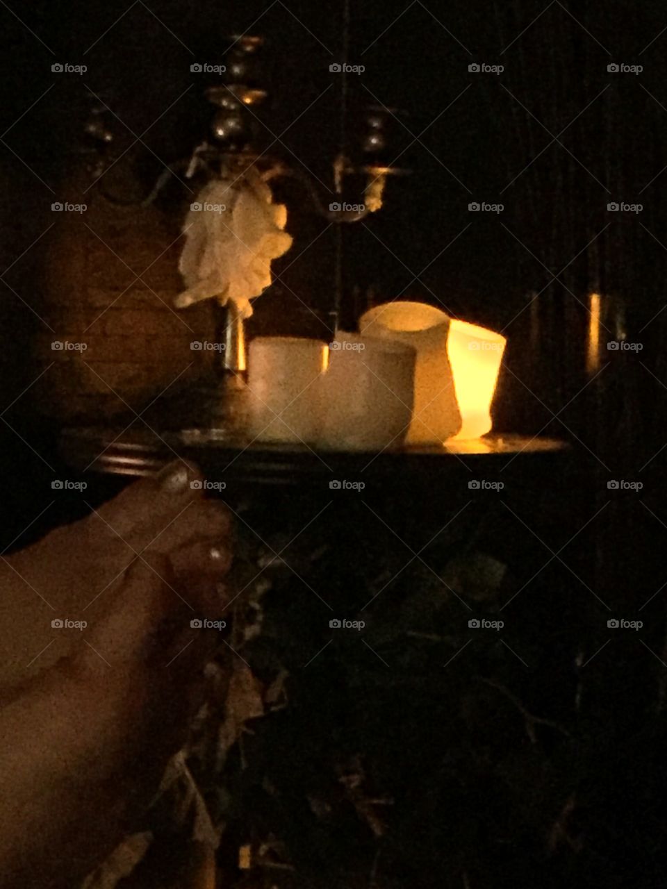 Relaxation by the fire with candles burning in the distance to create a soft glow in the evening