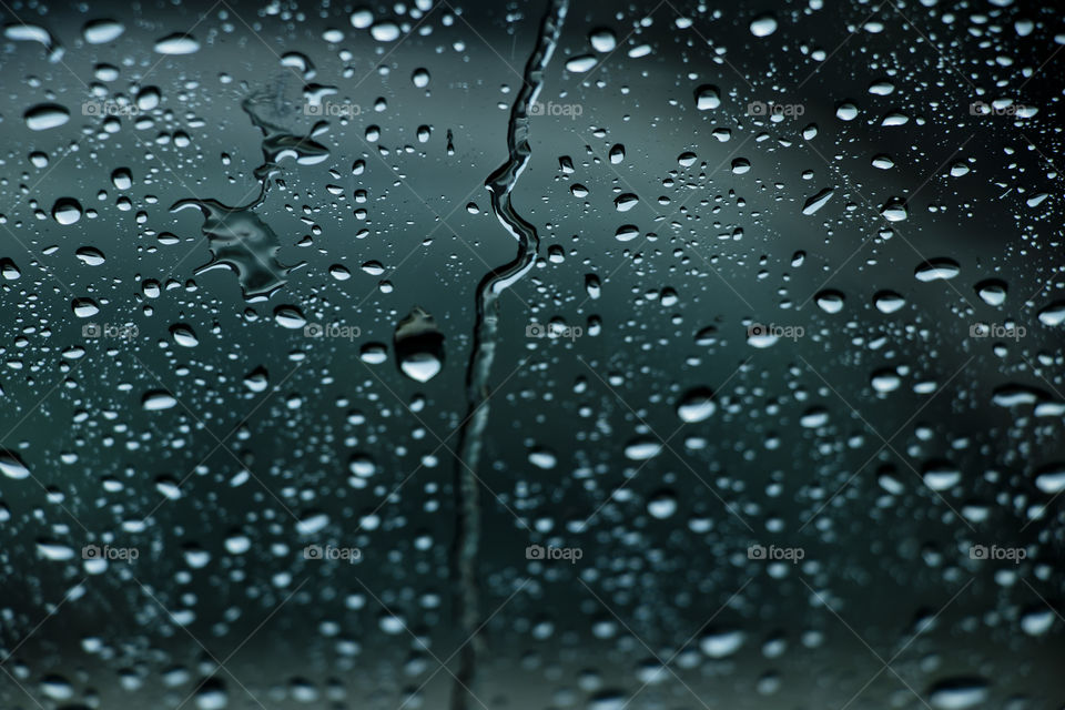 Rain falls outside the window.