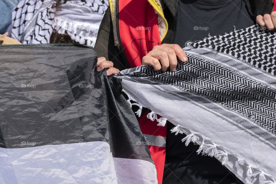 Close Up Holding A Flag And A Keffiyeh Shawl At The Student Demonstration Free Palestinian At The UVA University Amsterdam The Netherlands 7-5-2024