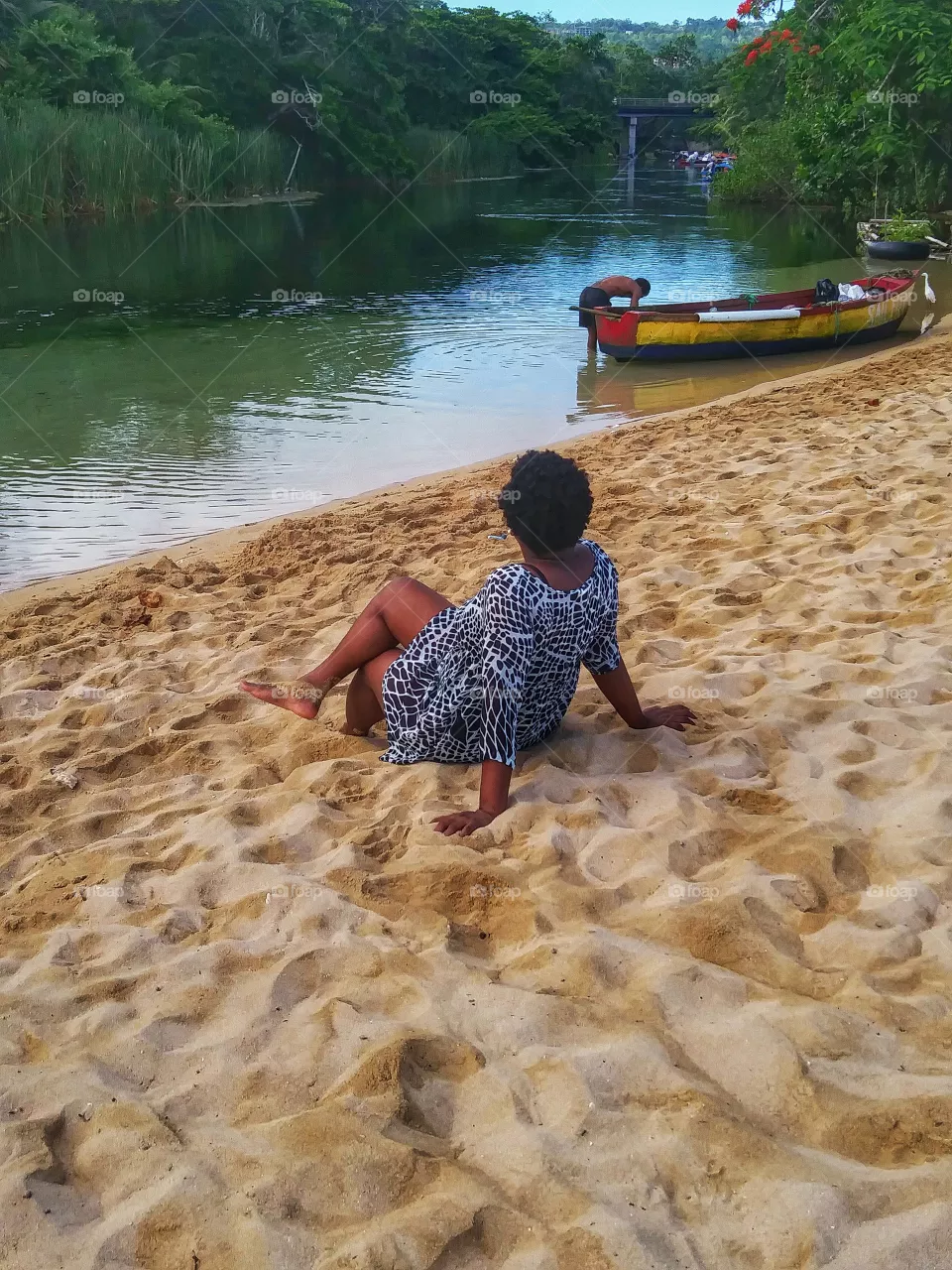 young woman sitting on the sand at the Beach