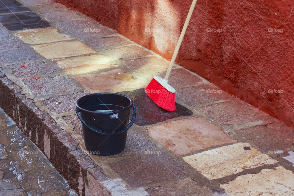 A bucket with soapy water on the street in San Miguel de Allende, Mexico