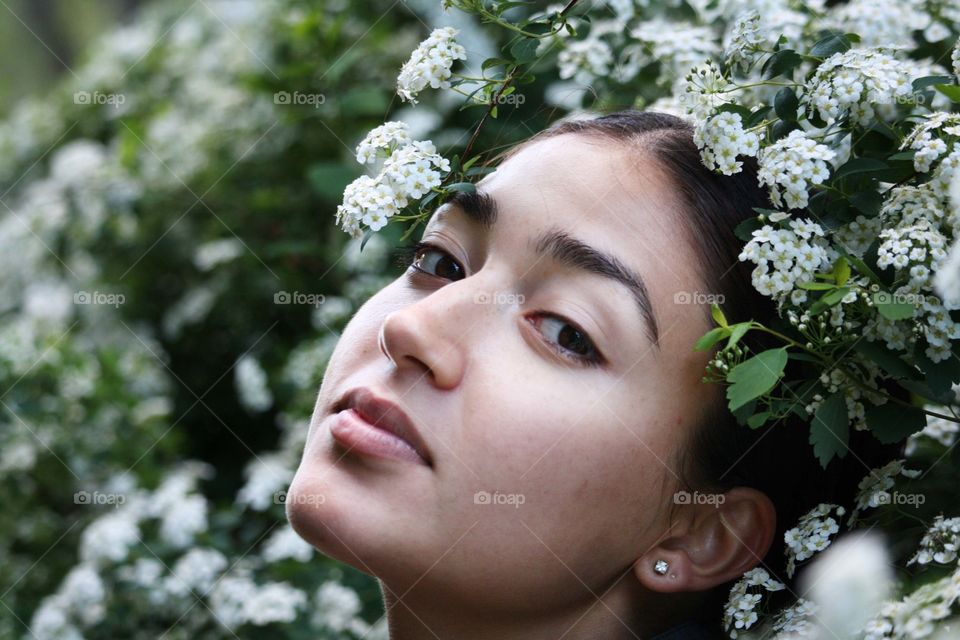 Portrait of a young woman in white flowers