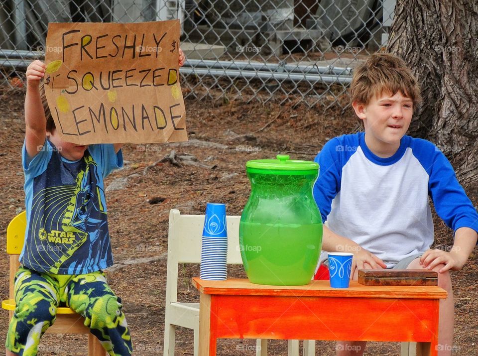 Childhood Lemonade Stand. Young Brothers Selling Homemade Lemonade In The Summertime
