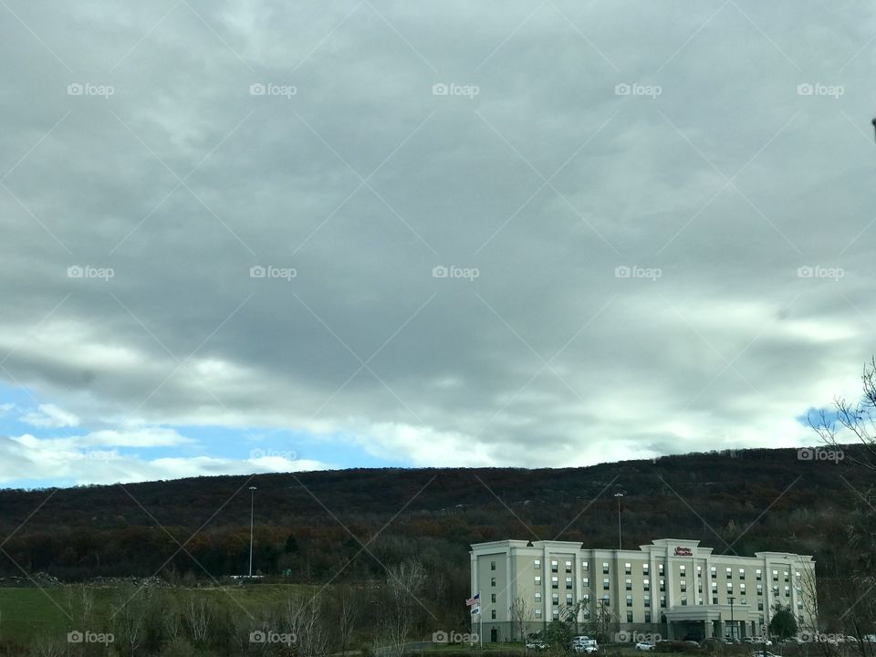 Large white hotel on the side of mountain 