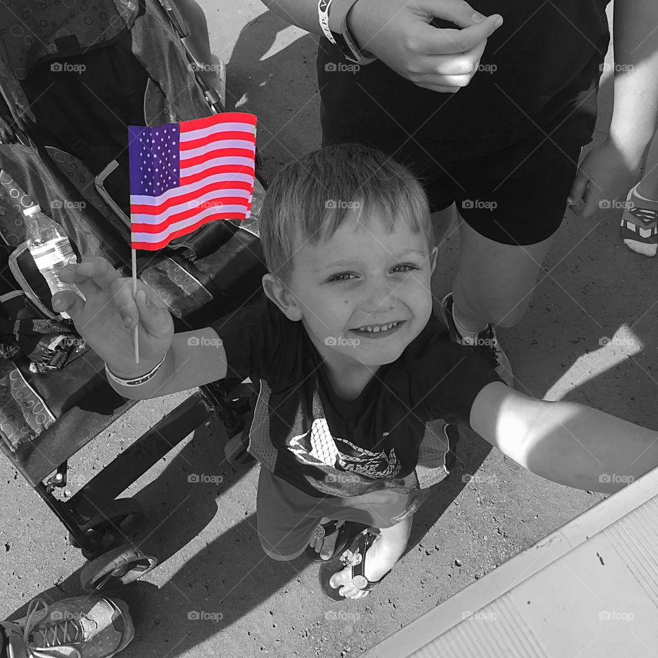 Small child holding flag in his hand
