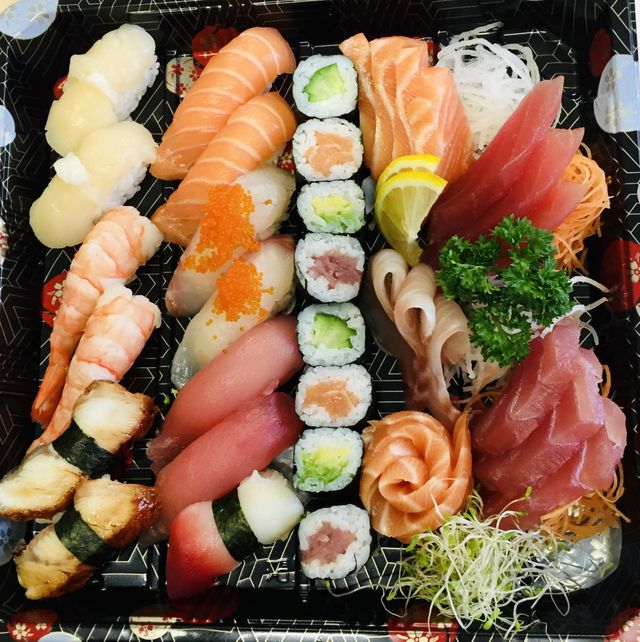 Fresh Japanese sushi assorted platter, Japanese Asian cuisine, sashimi on black tray from above 