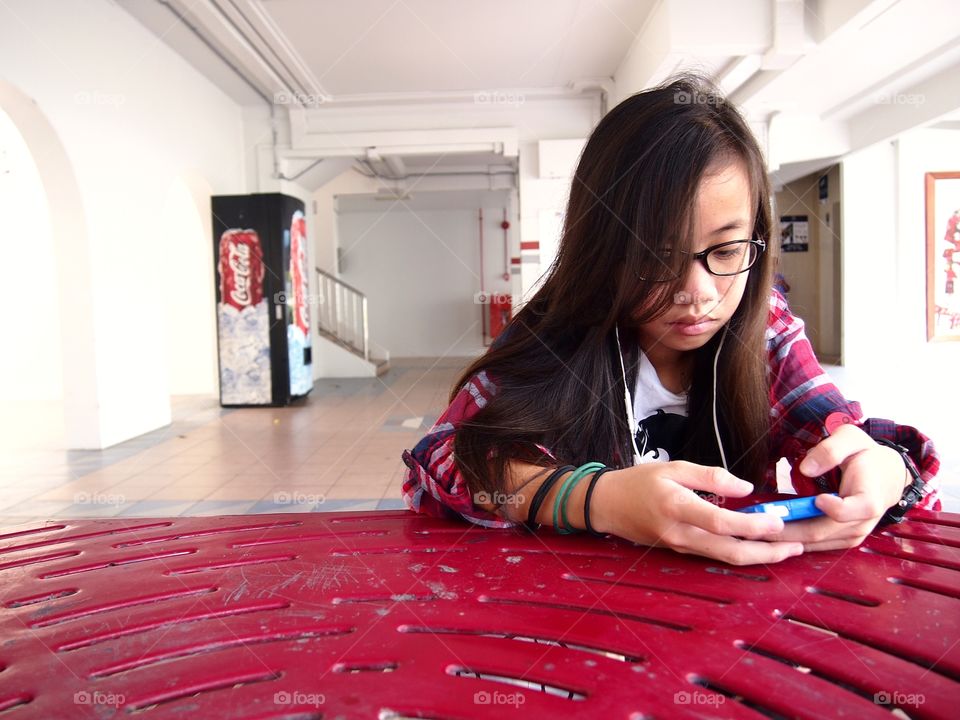 young girl using a smartphone or cellphone