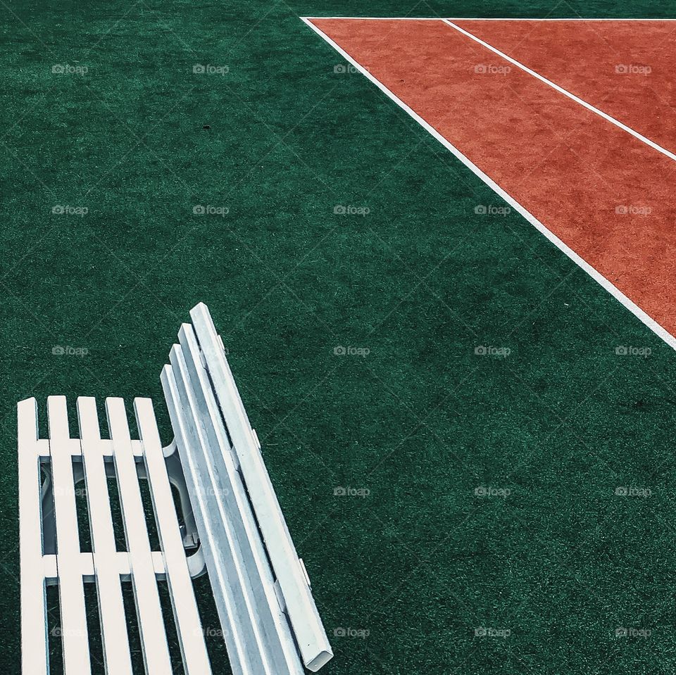 Empty bench in tennis ground