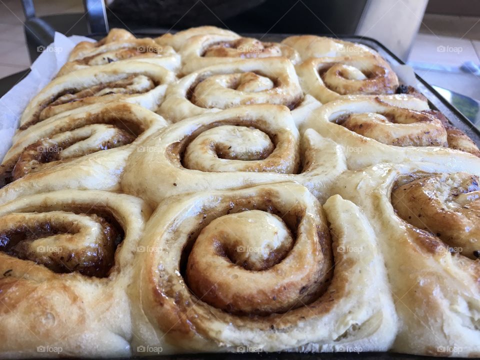 Cinnamon rolls scrolls fresh baked topped with maple syrup glaze