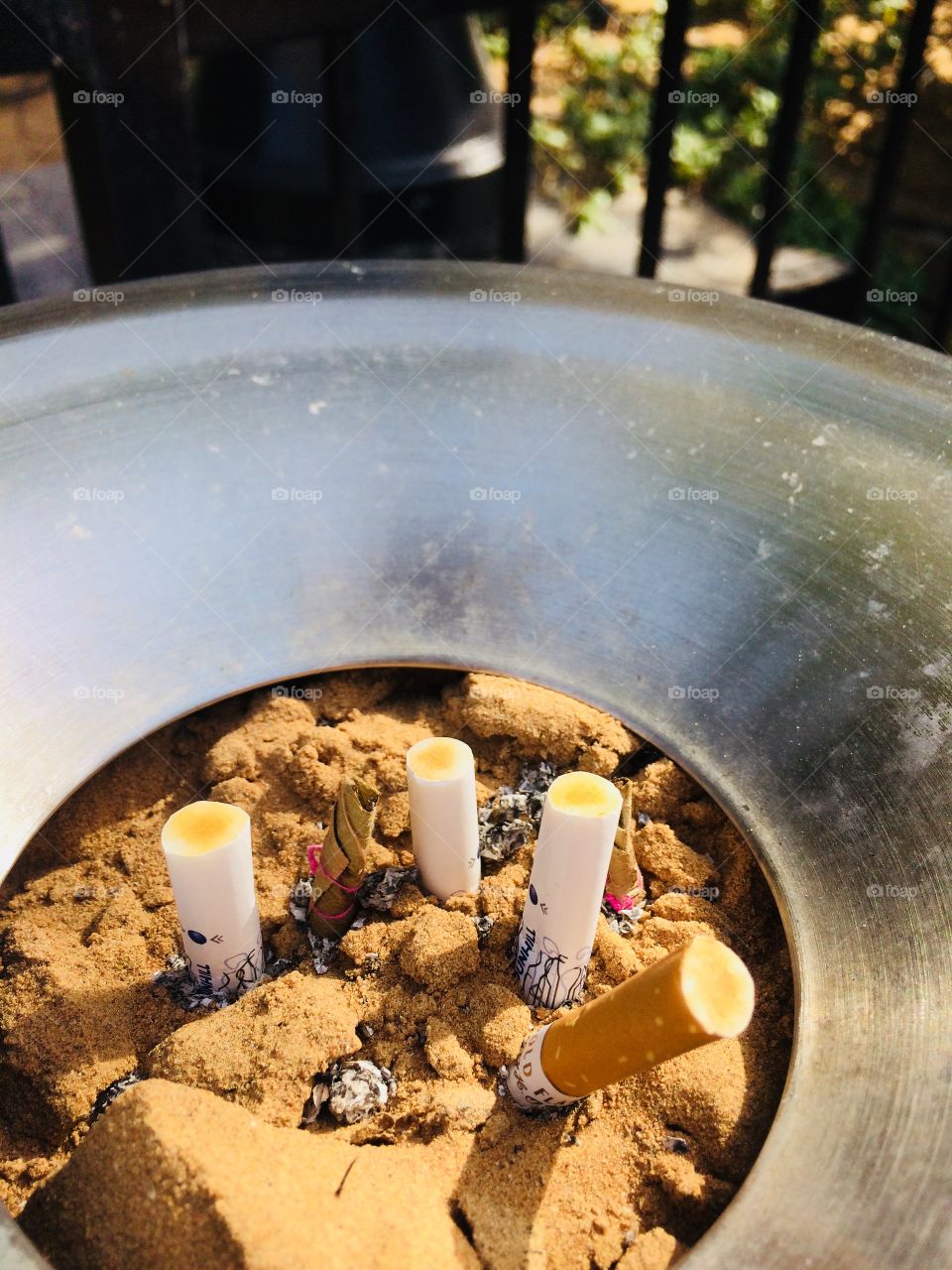 Cigarette buds buried in sand