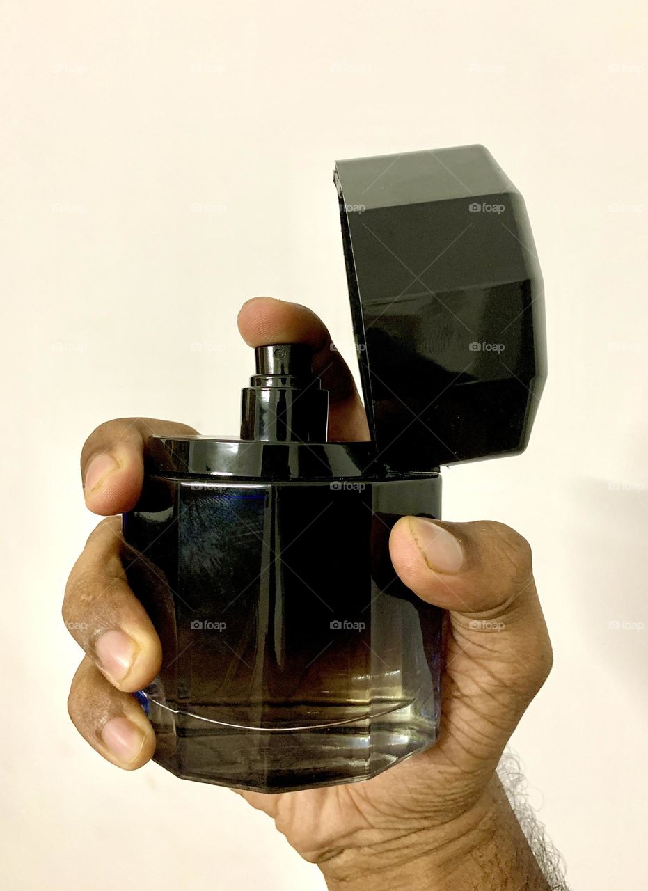 Perfume bottle holding in hand