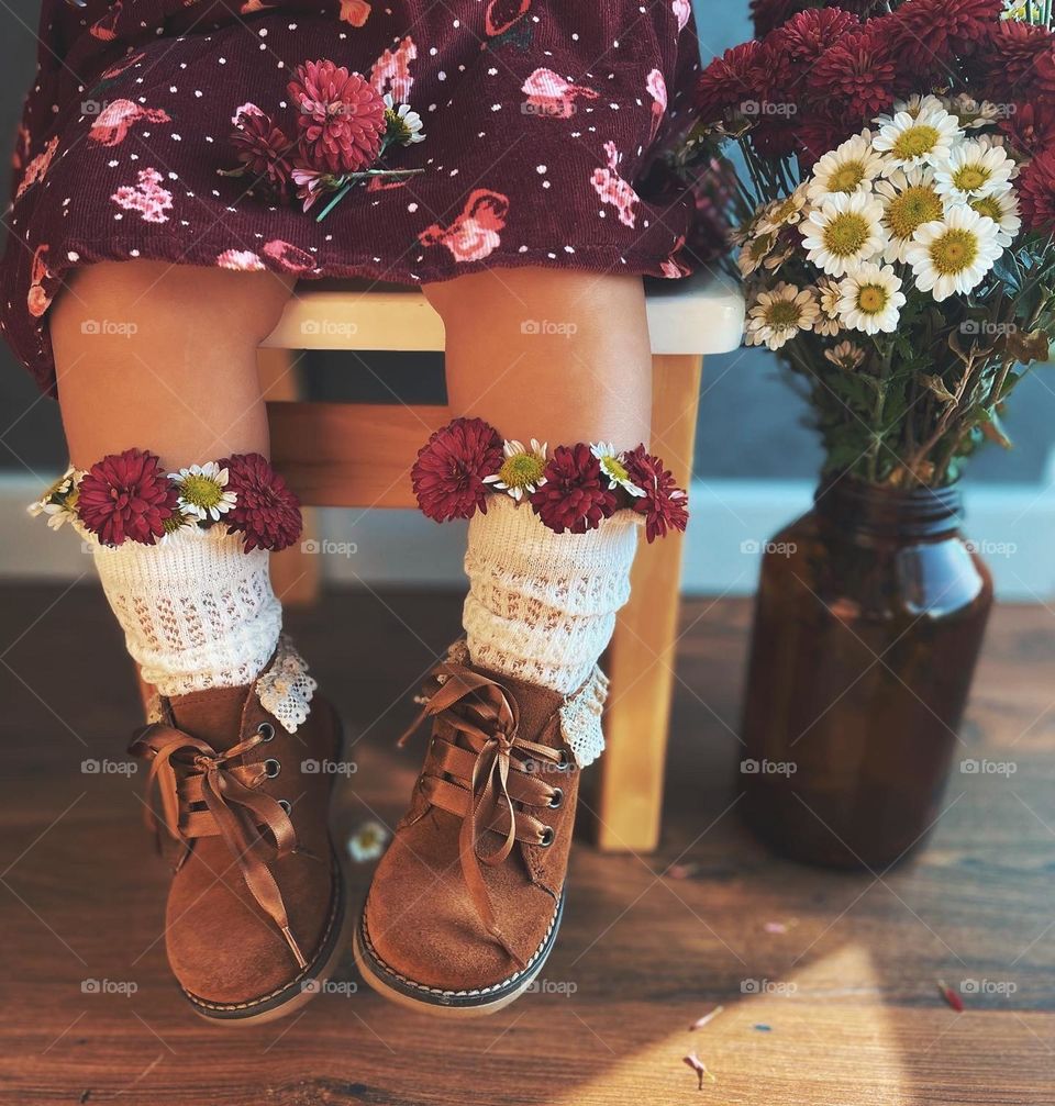 Baby girl with flowers in shoes 