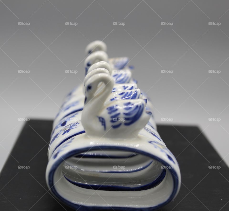 6 Porcelain Swan Napkin Rings in a row