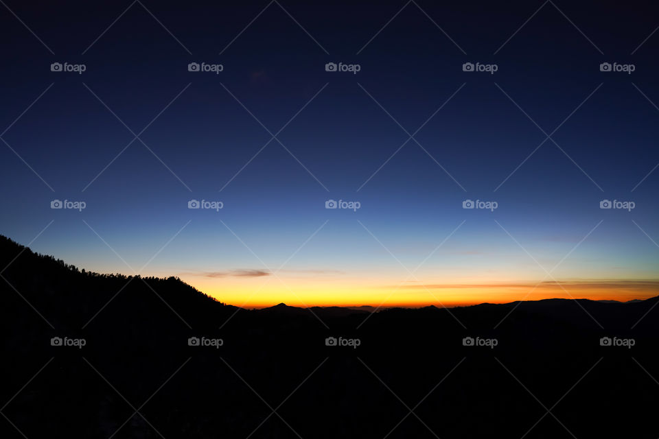 Sunset view in the mountains with silhouette mountains 