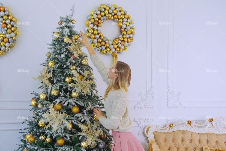 girl decorates the Christmas tree