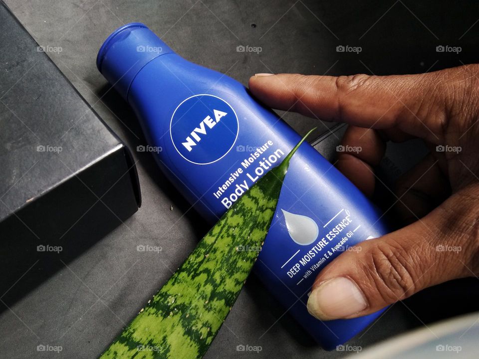 leaf in natural pattern and Nivea. holding by hand