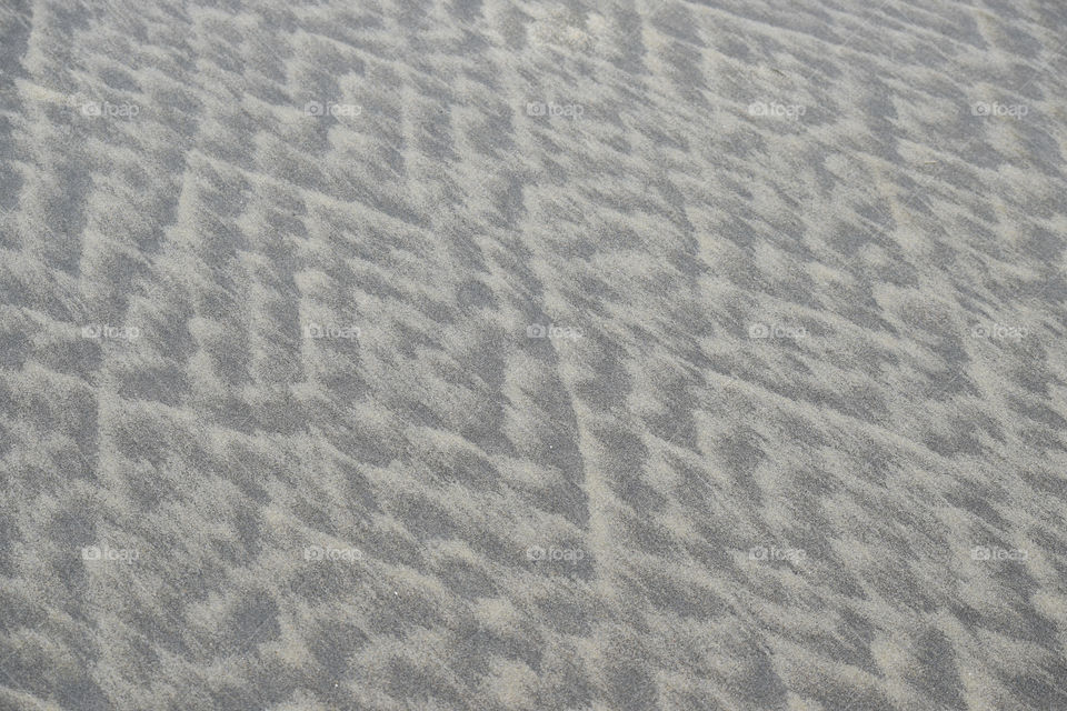 Beach sands naturally lined and shaped by the sea waves.