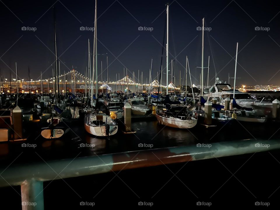 San Francisco bay bridge with sailboats in the marina 