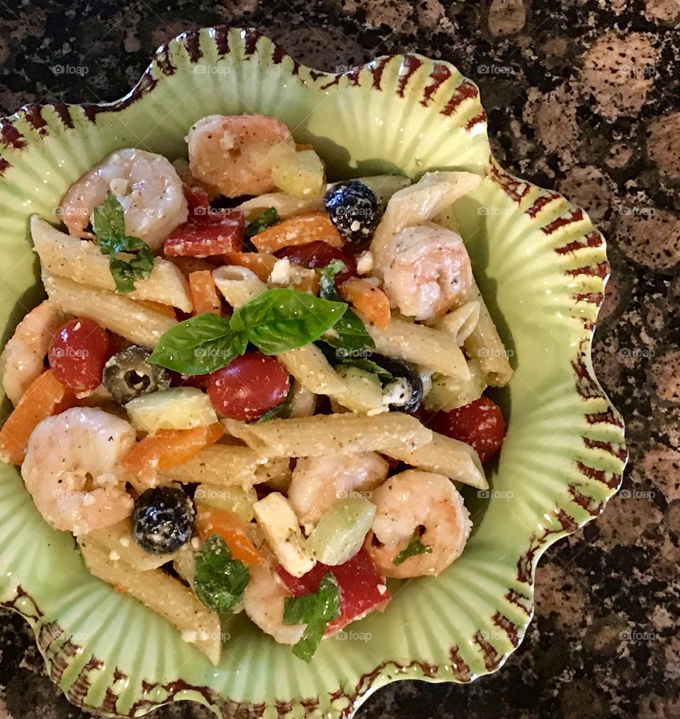 Shrimp, veggie and pasta salad in seashell bowl 