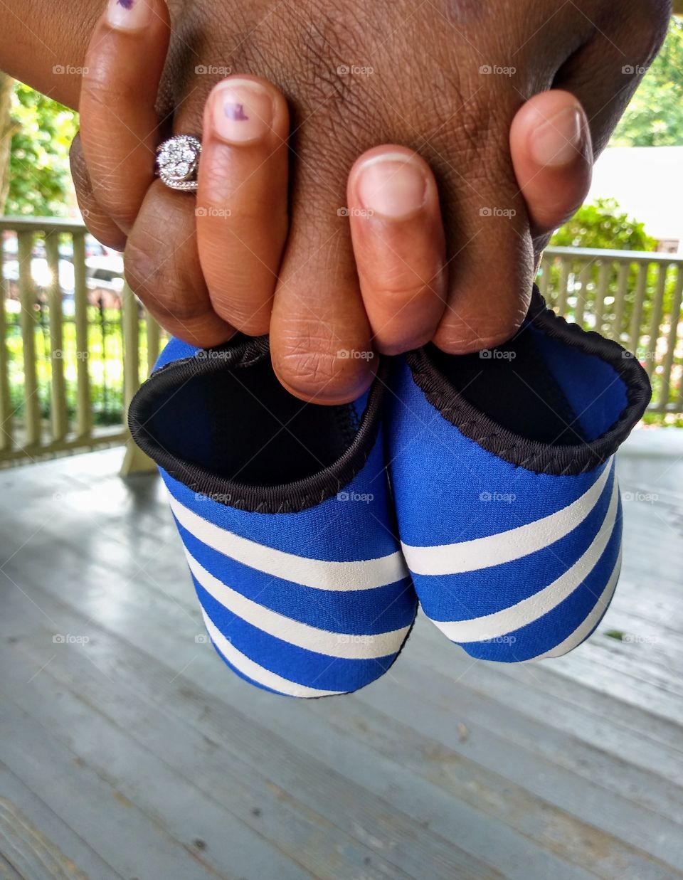 hands holding baby boy shoes