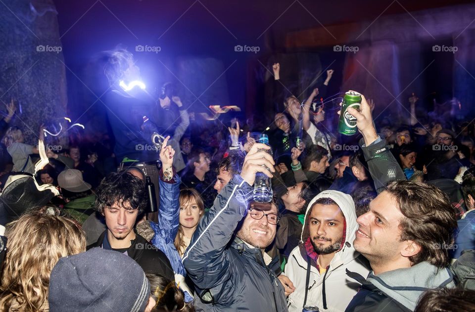 A crowd of revellers partying until dawn to see in the Summer Solstice at Stonehenge 