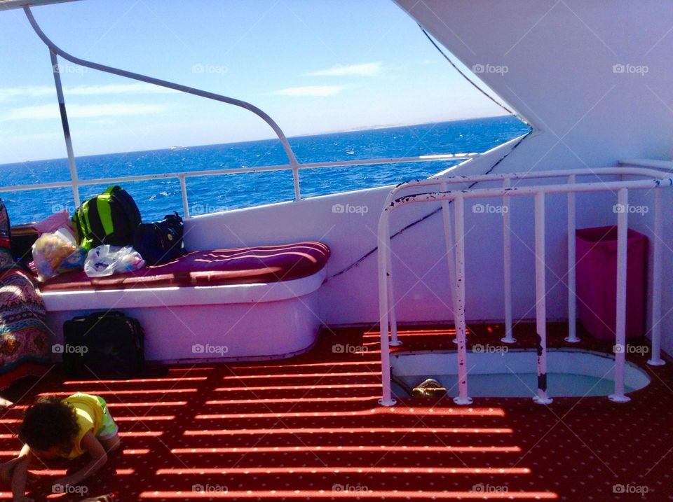 A little child playing on the boat during summer vacation 