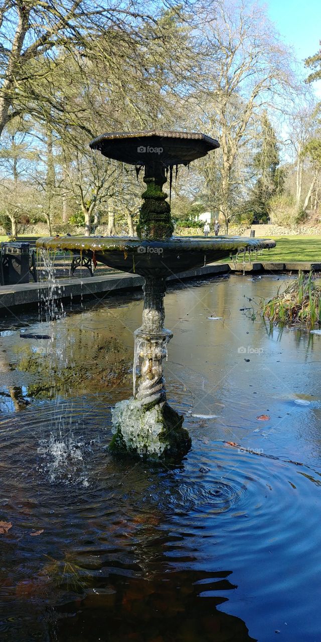 fountain in pond at park on cold winter mmorning