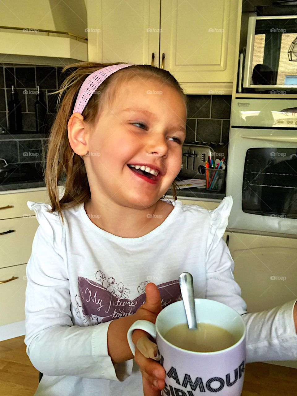 Cute girl with cup of milkshake