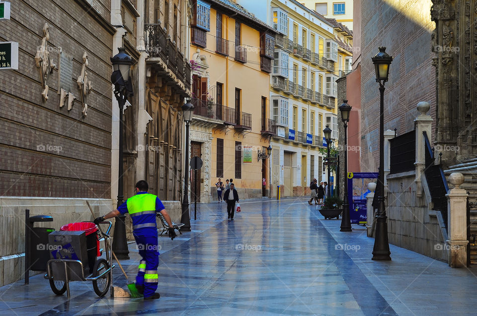 Men cleaning the street in the morning in Malaga city center 