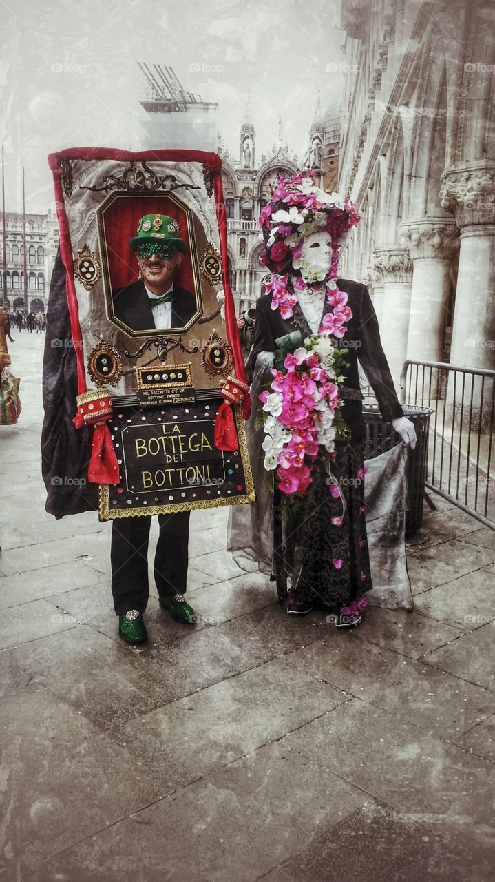 Two people in costume standing on street