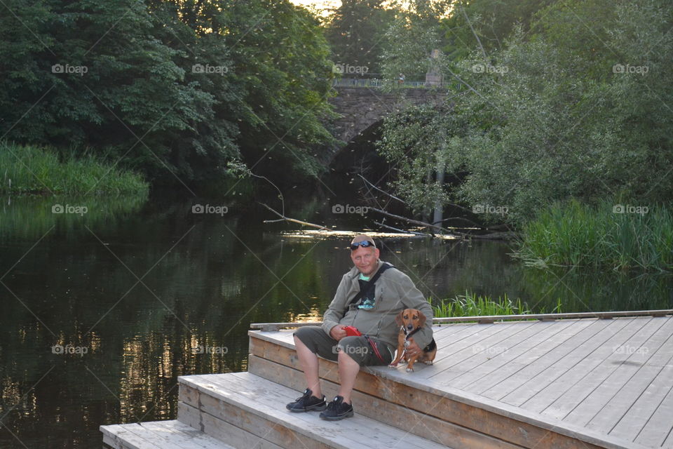 Man sittning with dog