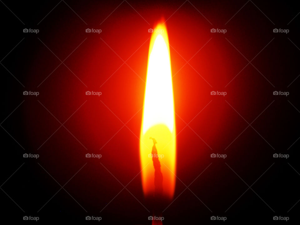 Red flame of a burning candle.  Macro photography.
