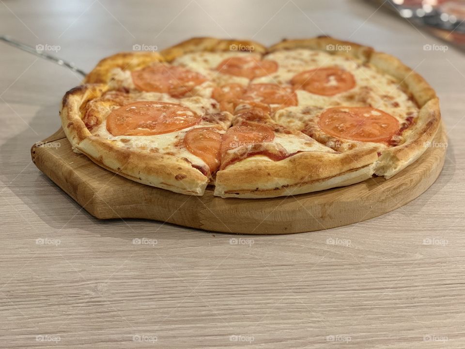 pizza Margherita with cheese and tomatoes