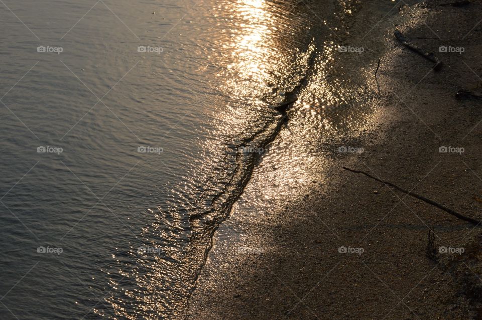 Beach front sun glowing on water 