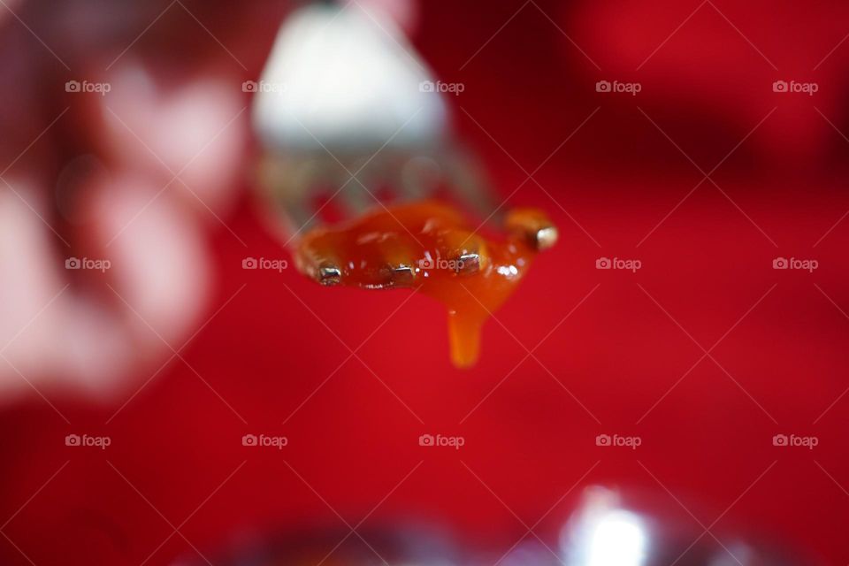 A fork drizzling in ketchup (For Alan)