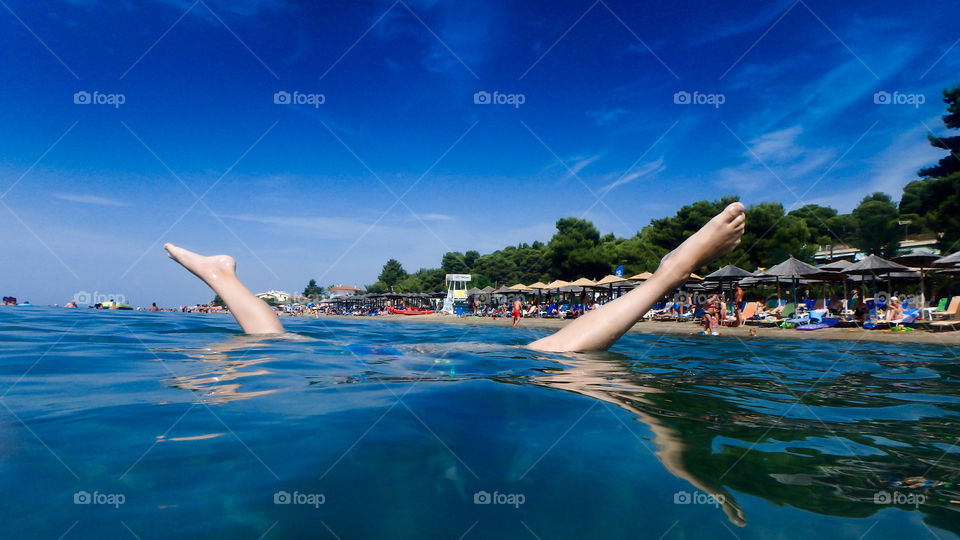 Close-up of person's leg in water