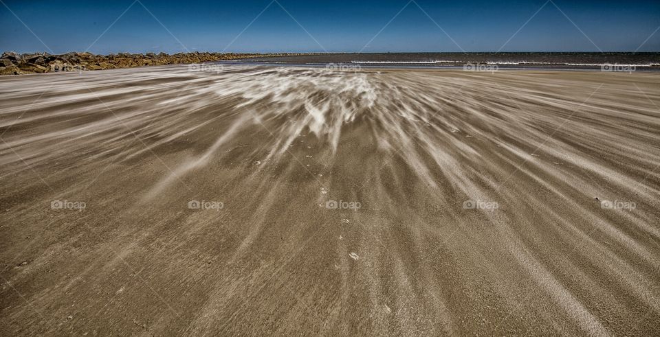Sand blowing down the beach on a very windy day