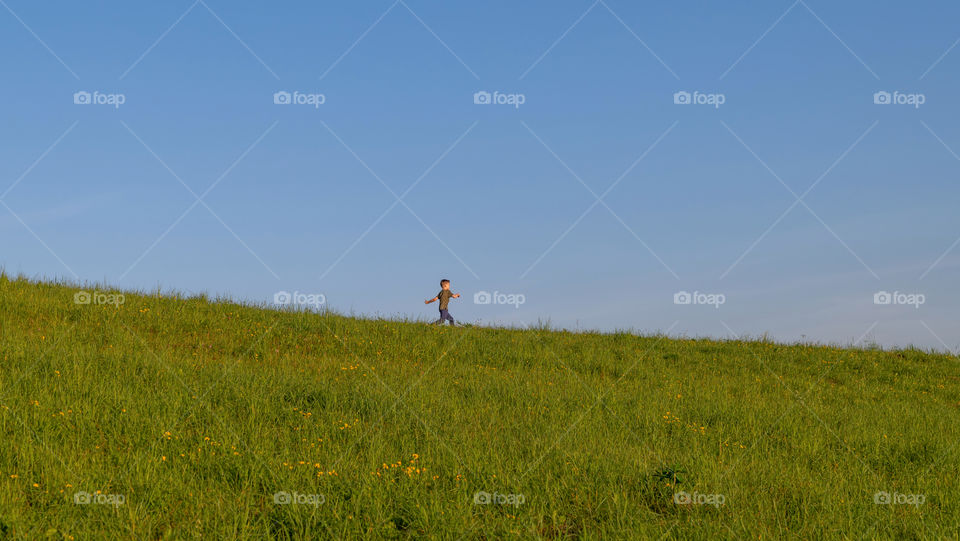 Boy running on meadow.