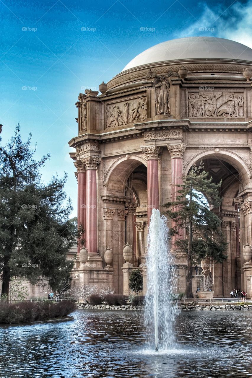 Vintage looking image of the landmark Palace of Fine Arts in San Francisco California with the fountain rising through the lagoon on a warm sunny afternoon 