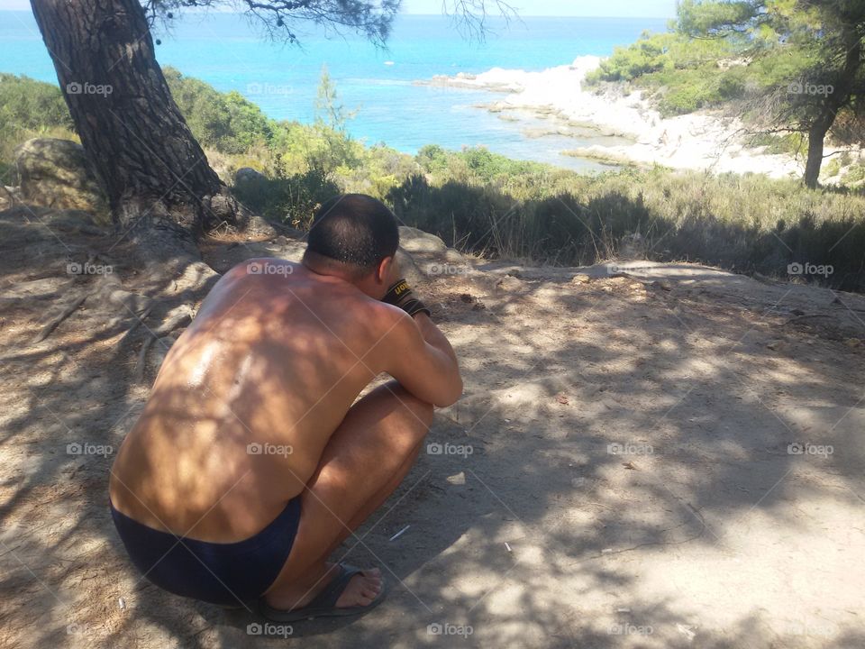 Man with camera on the beach