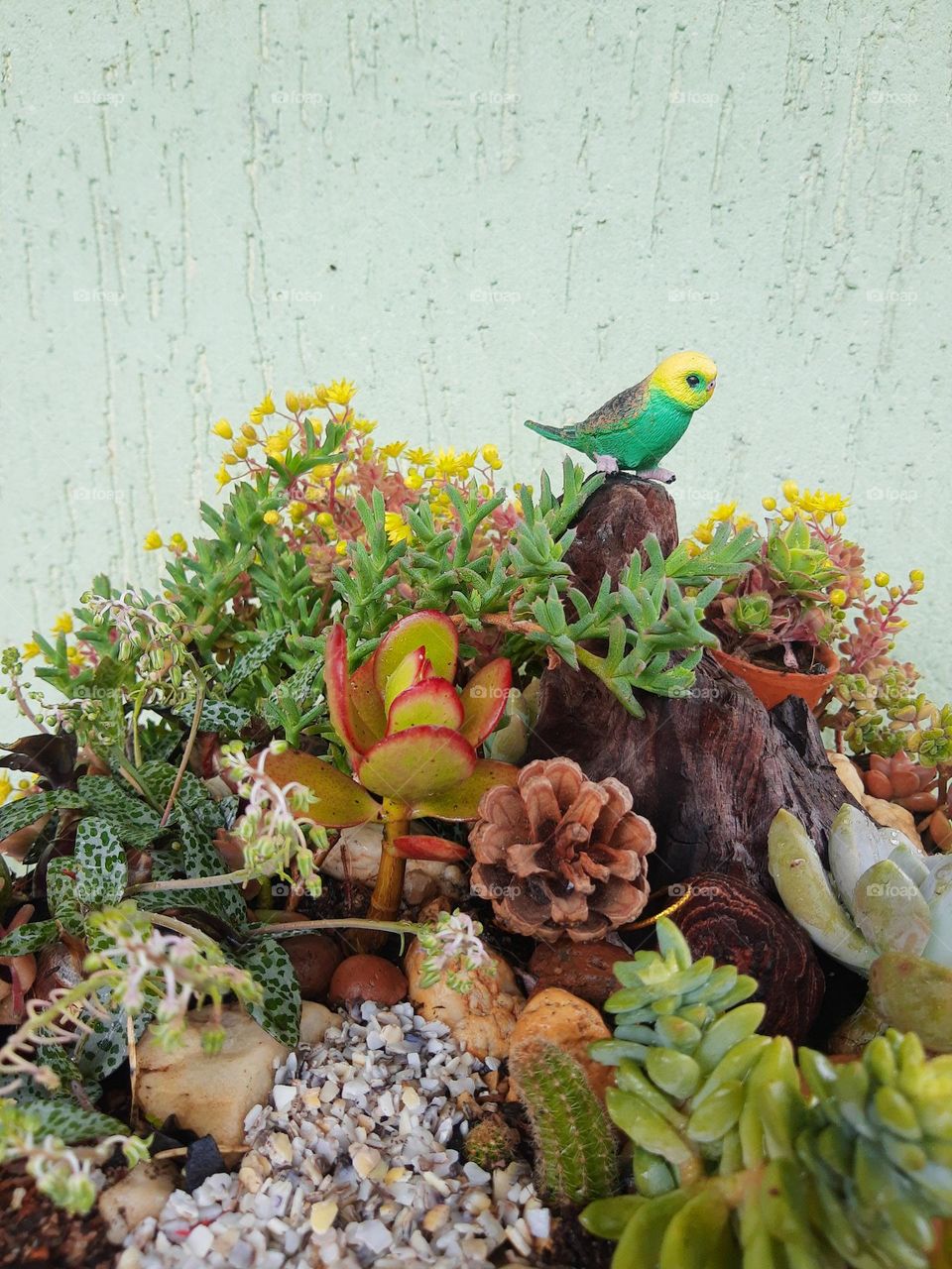 a small bird on a tropical plant's arrangment