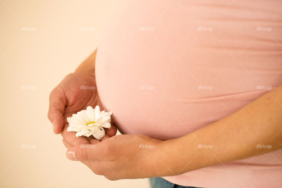 Pregnant woman holding flower