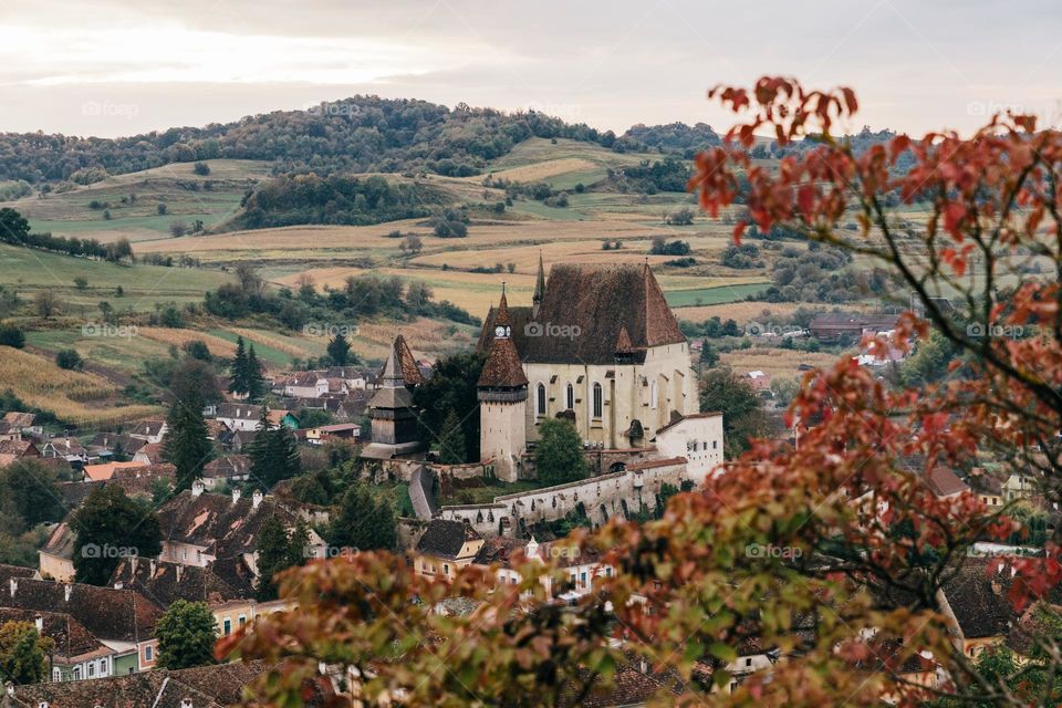 The fortified church of Biertan, located in Transylvania region, Romania; pictured in a autumn colored landscape.