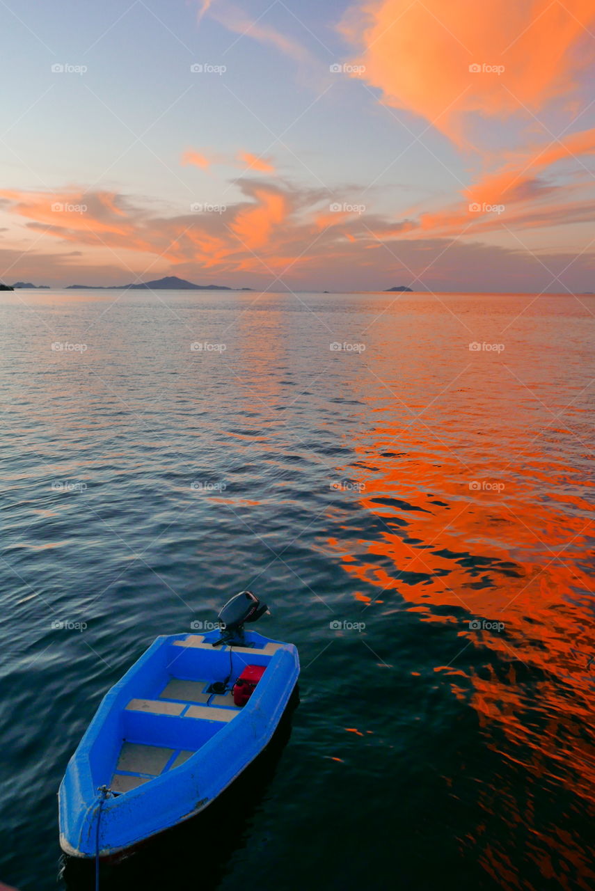 Blue boat orange sky sunset , Indonesia 