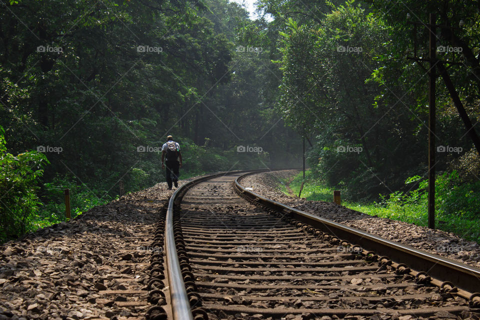 Man walking near by railway track