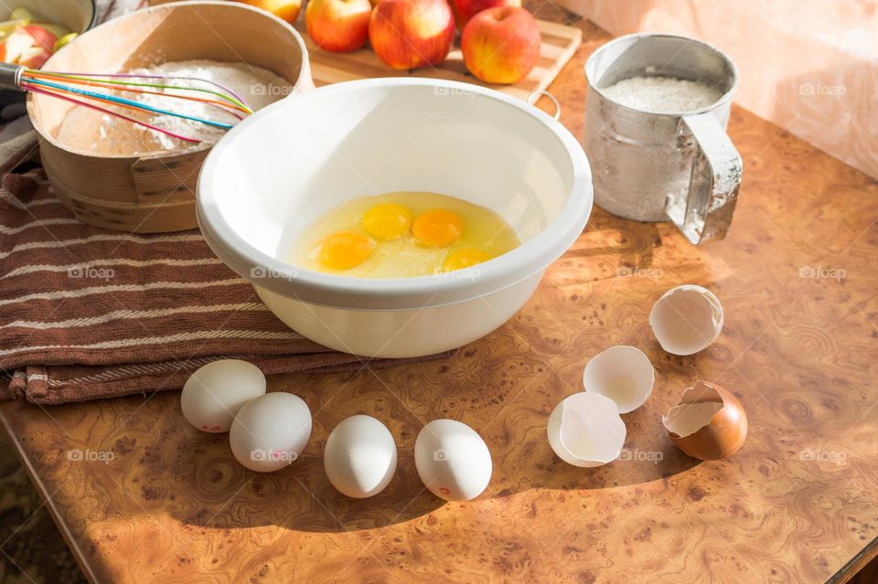 Making homemade puffed apple pie with eggs, sugar and flour.
